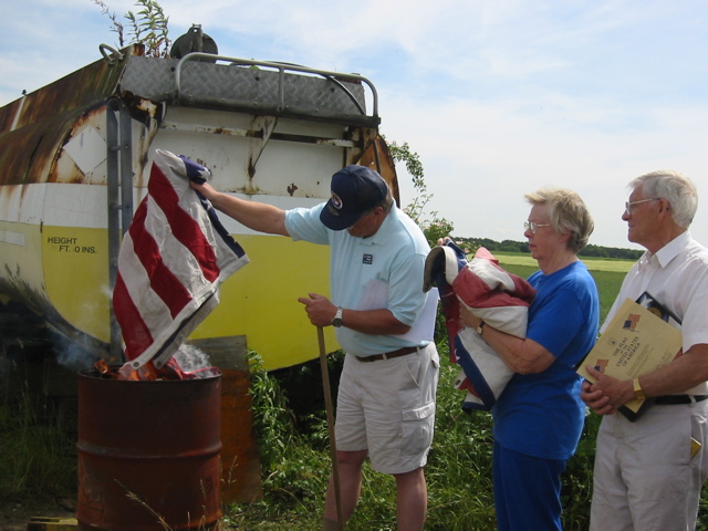 Randy burning worn 398th Flags at Ceremony